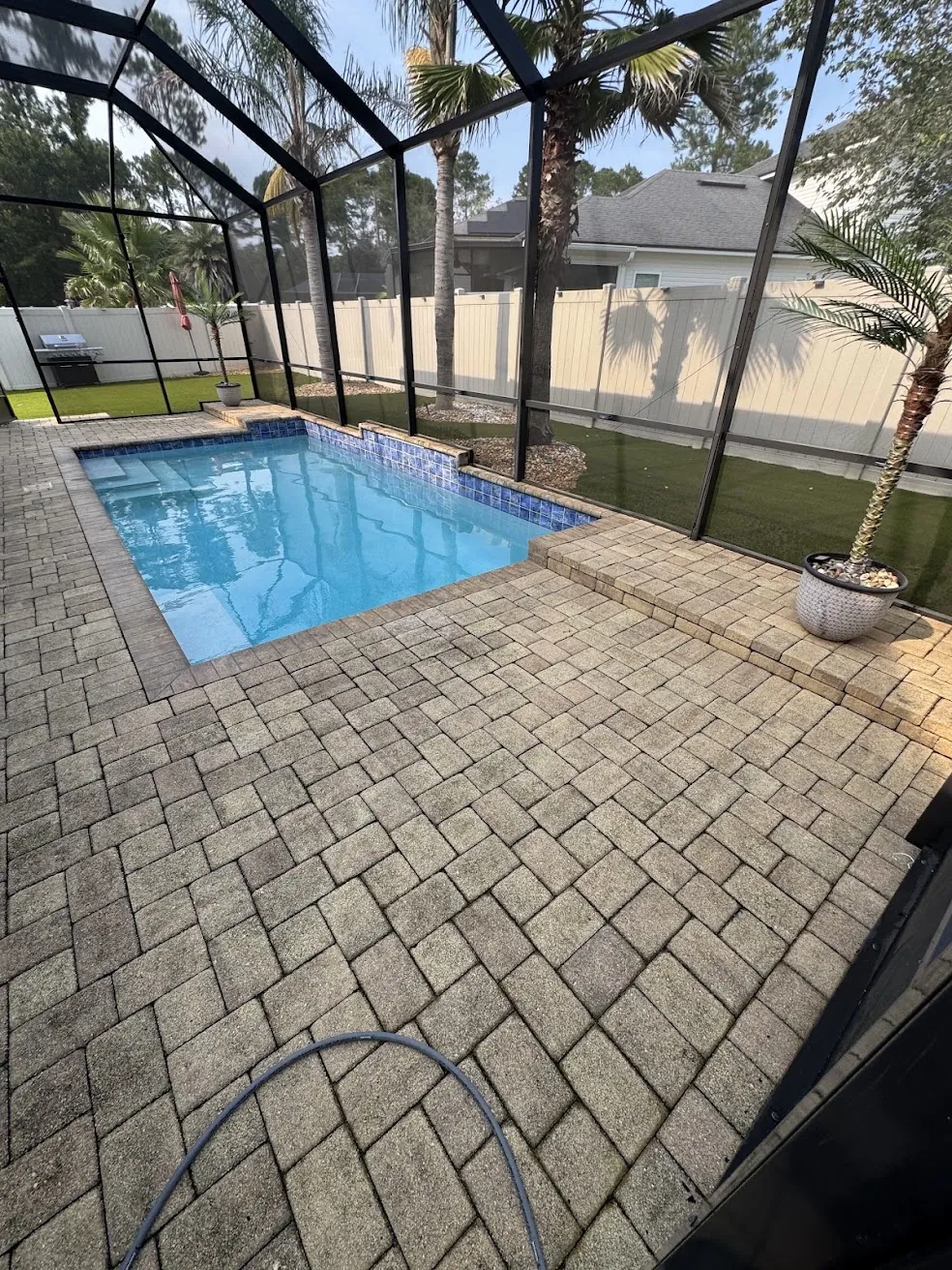 Screened pool deck pavers being cleaned before sealing