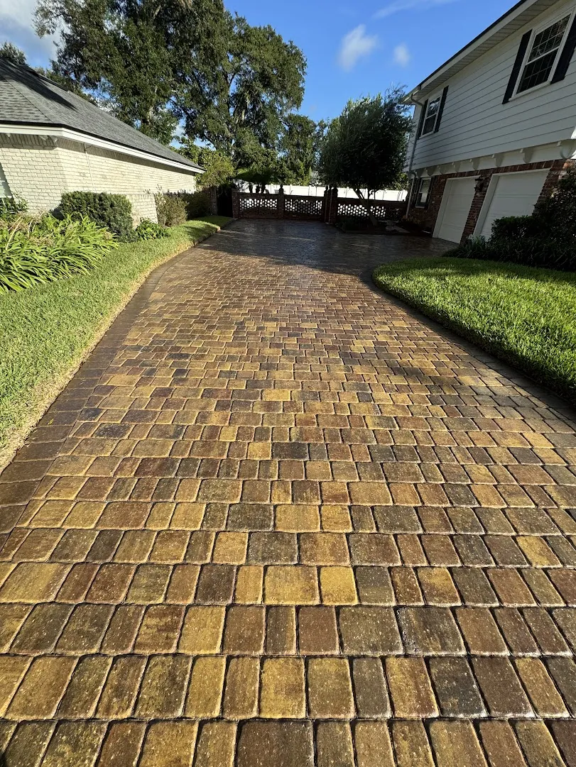 Long paver driveway cleaned and sealed by Glow Guys in Jacksonville, FL