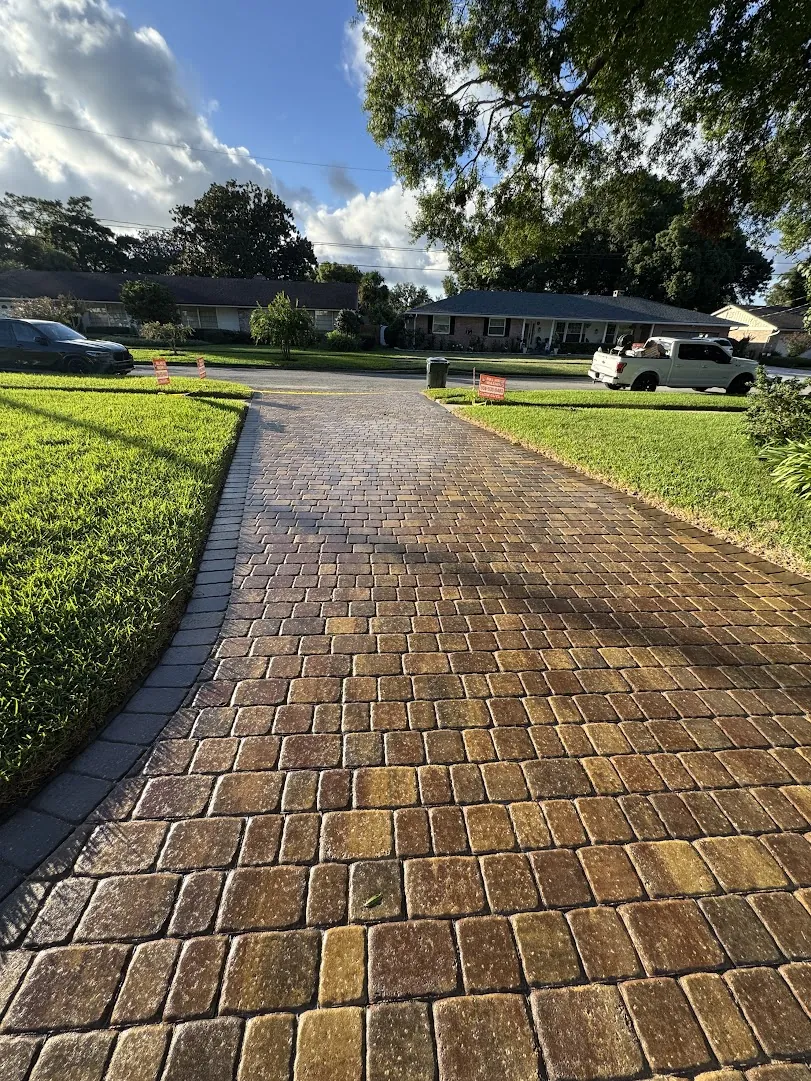 Curved paver driveway after a full cleaning and sealing
