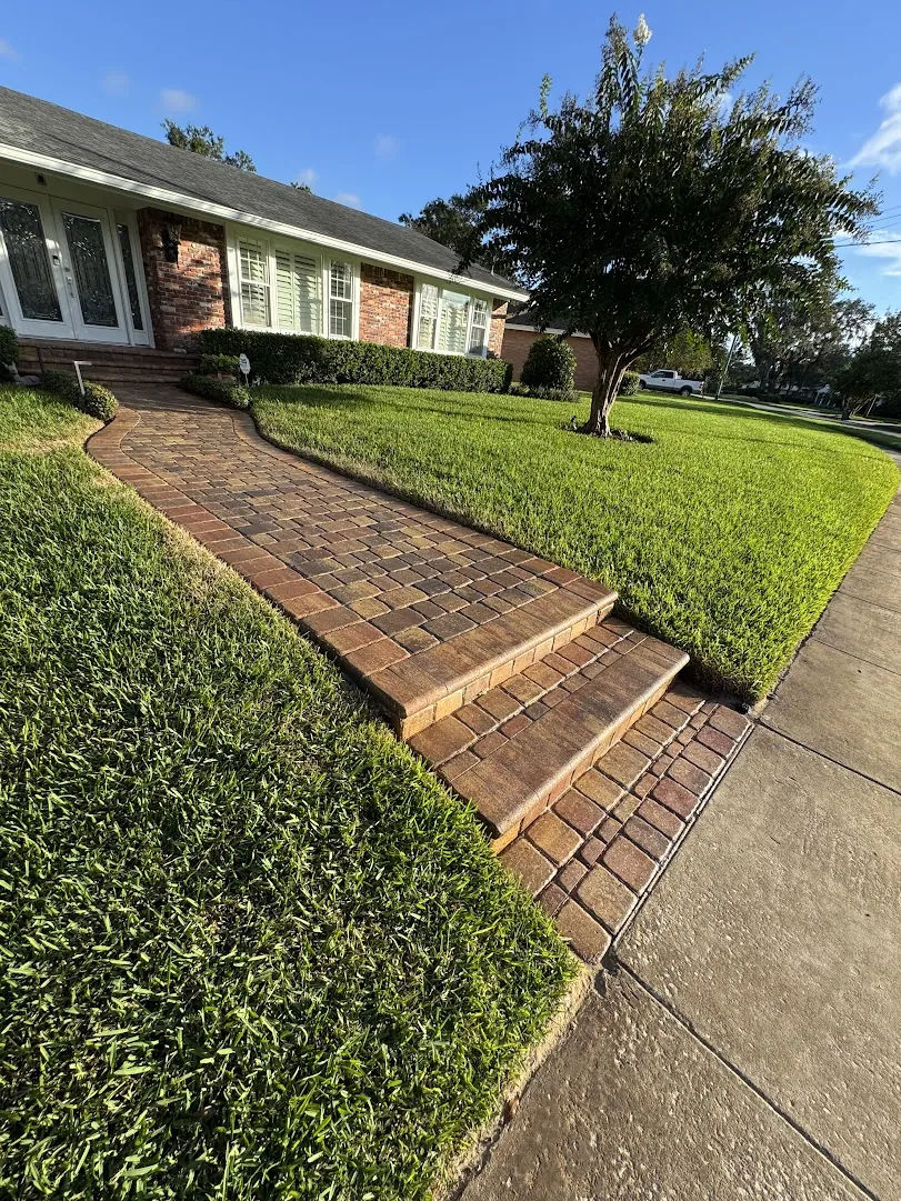 Wide view of a paver driveway and walkway after a full cleaning