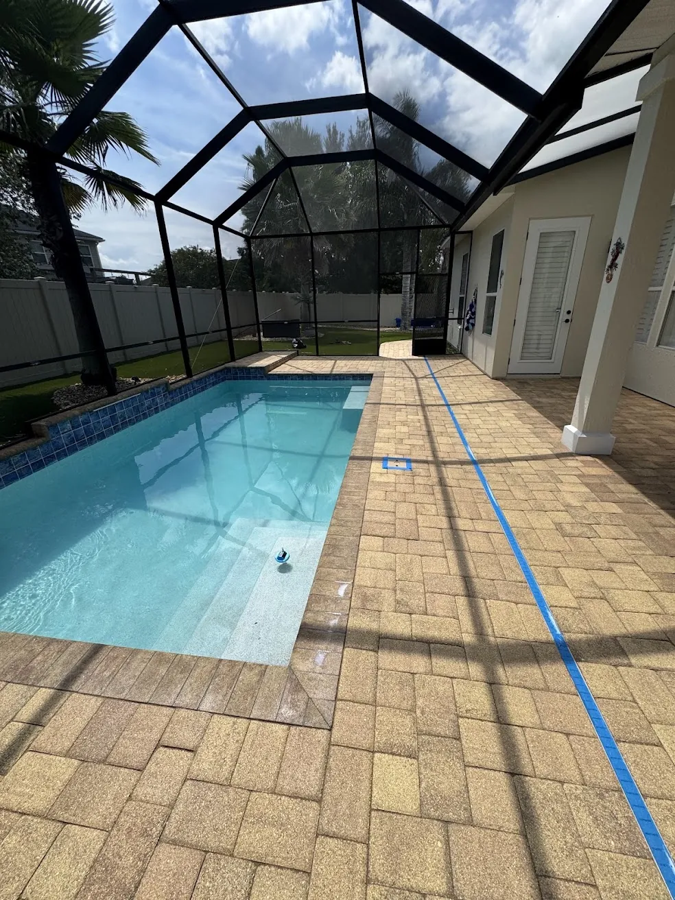 Screened pool deck pavers cleaned and sealed to a uniform golden finish