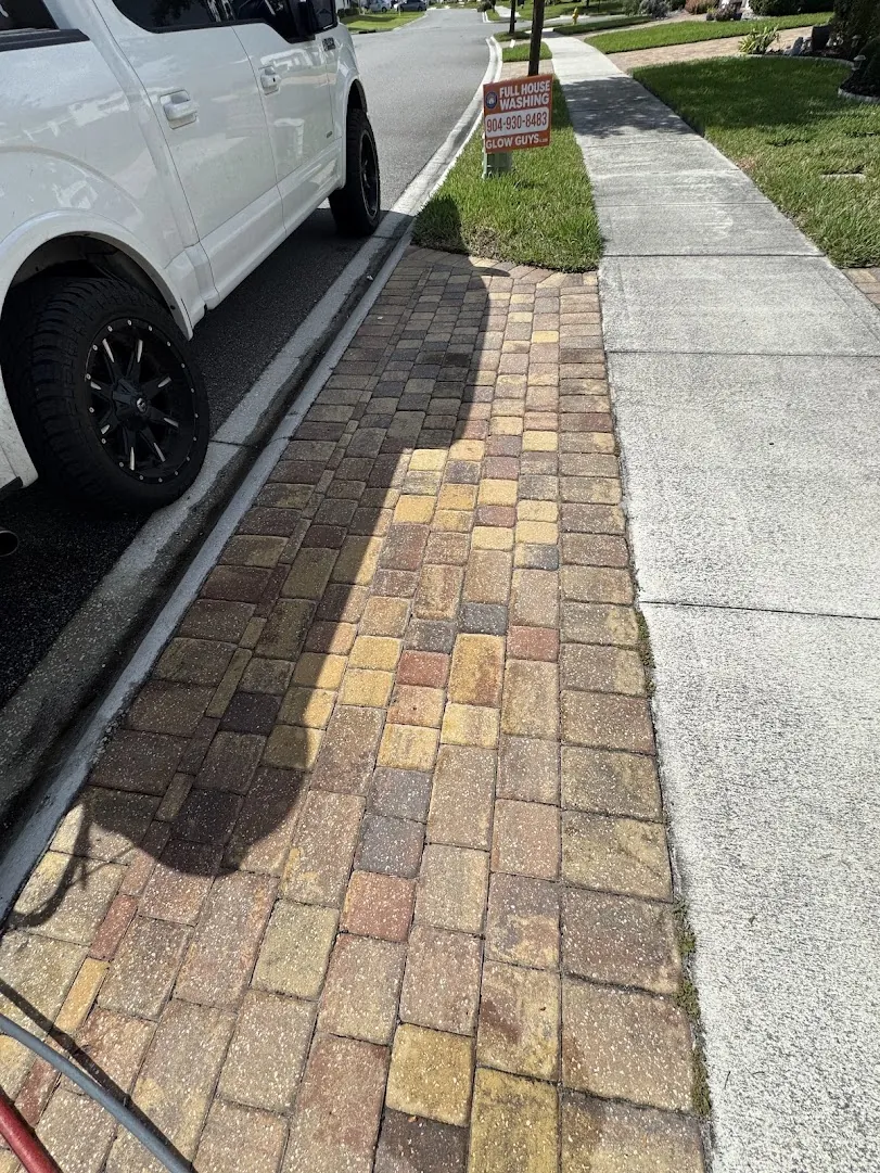 Sealed paver driveway beside the sidewalk with a color-enhanced finish