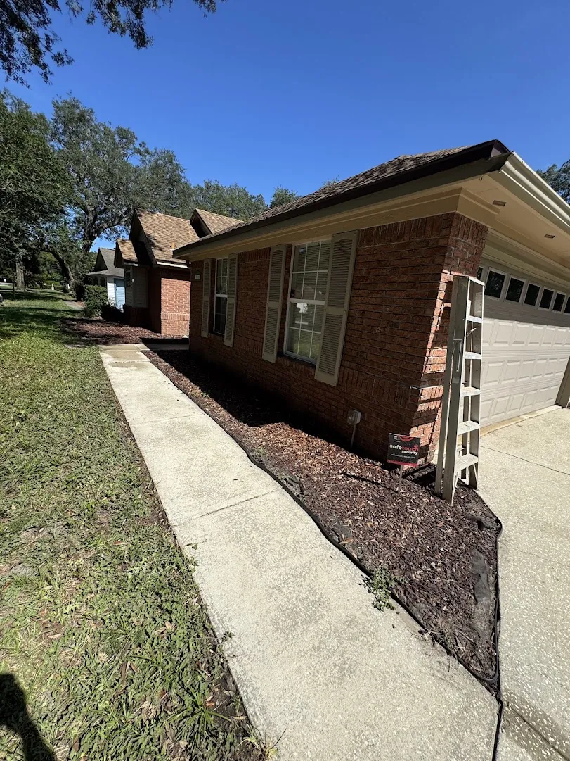 Freshly washed home exterior and driveway with clean siding and bright curb appeal