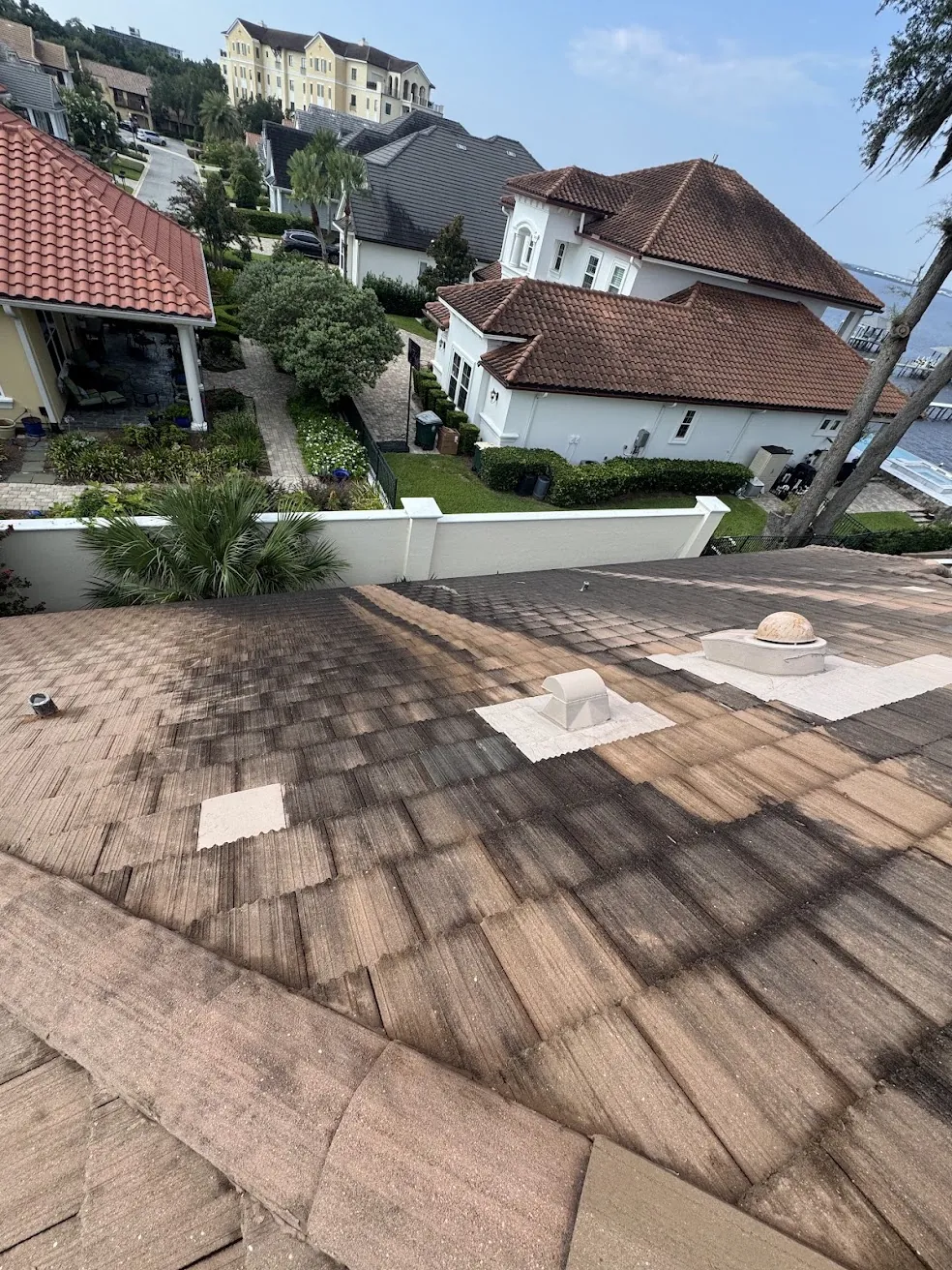 Tile roof in a Jacksonville neighborhood being prepared for a soft-wash roof cleaning